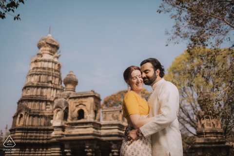 Indian boy and Australian girl in kurta and saree, exploring Maharashtra temple, celebrating cultural heritage.