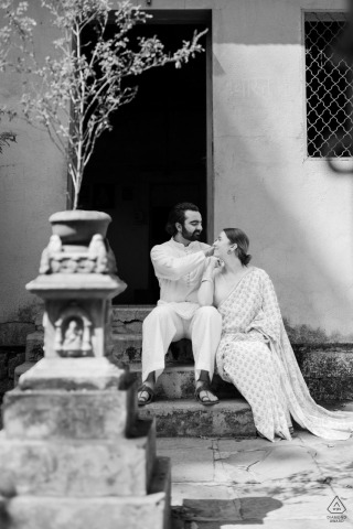 Couple in traditional Indian attire, Maharashtra house and Tulsi plant backdrop, celebrating heritage and love.