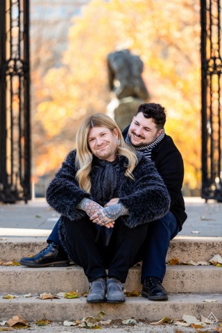 A couple sits closely together on the stone stairs outside the Rodin Museum in Philadelphia.