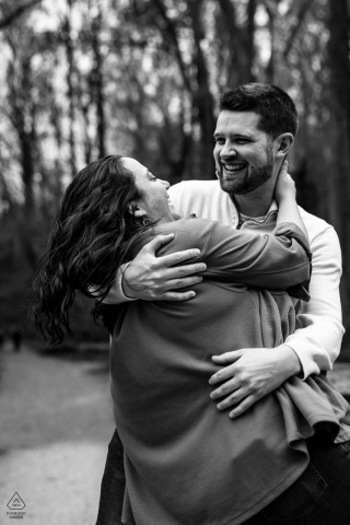 A couple in Wissahickon Park laughs together, trying to come out of a playful dance dip.