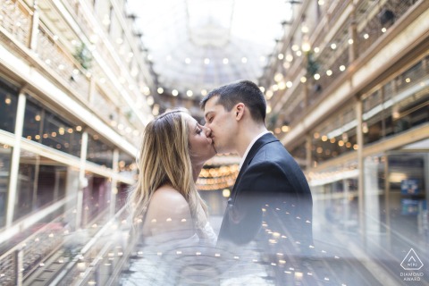 Engaged Couple Shares Romantic Kiss in Historic Arcade, Cleveland, Ohio Engagement Portrait Engaged couple kisses in this romantic portrait, in historic Arcade Cleveland, Ohio setting.