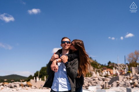 Couple’s portrait in Portopiccolo, wind blowing through their hair, romantic seaside portrait.