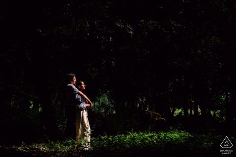 A couple poses together in beautiful Bergschenhoek sunlight, smiling warmly amidst scenic Dutch surroundings.