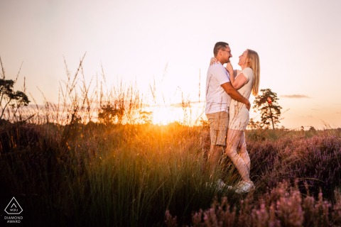 Engaged couple at Loonse en Drunense Duinen, embracing during an amazing sunrise pre wedding shoot.