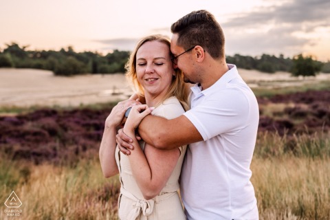 Engaged couple poses for a beautiful close-up at Loonse en Drunense Duinen sunrise photoshoot.