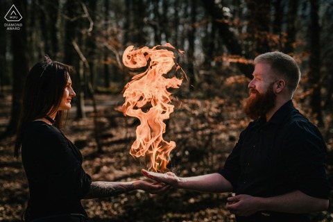 Fiery Engagement: German Couple's Portrait Features Hands Aflame in Münsterland Münsterland, Germany — An engaged couple poses with flames rising from their hands.