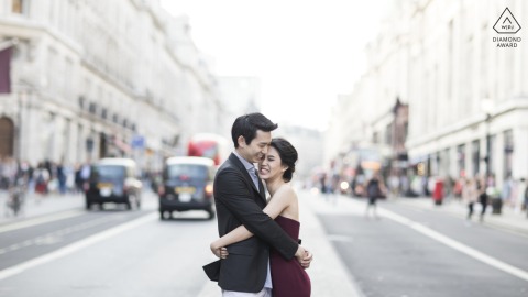 A couple's urban engagement portrait in London, UK, standing on a busy road.