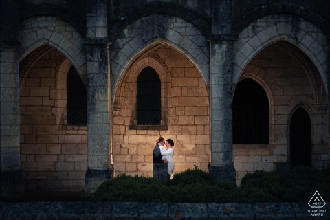 Brantôme, Périgord, France. Couple in love standing under the stone archways.