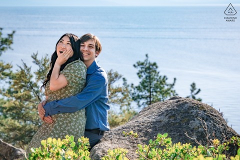 South Lake Tahoe proposal portrait. The couple is smiling on the cliffs.