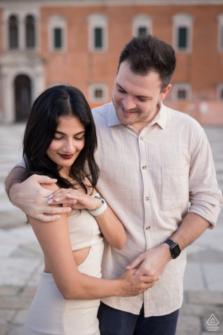 San Giorgio Island, Venice. A newly engaged couple poses, showing off the ring.
