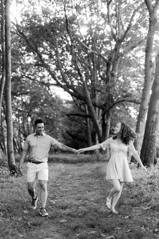 AUGUSTA, Maine — A couple holds hands during their engagement portrait session, celebrating their love story amidst the picturesque landscapes of the Maine outdoors.