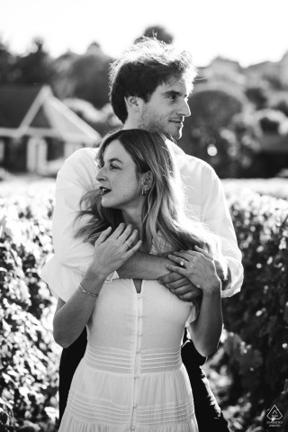 SAINT-EMILION, France — A couple embraces in a tranquil vineyard as the sun sets. Their tender connection is beautifully captured in a black-and-white portrait session.