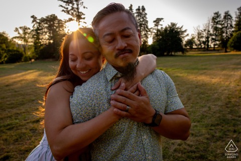 VEULLEROT, France — A couple is against a vibrant sunset at Château de Veullerot, their affectionate connection glowing in this romantic and intimate engagement portrait.