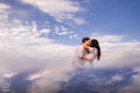 Sky Reflects As Couple Kisses Beneath The Falls In Niagara-on-the-Lake A couple kisses in Niagara-on-the-Lake, with sky reflection visible beneath them.