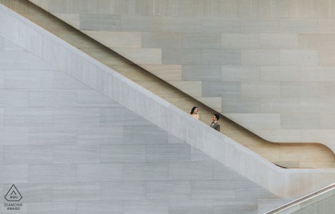 Modern Museum Engagement at the National Gallery of Art, Washington D.C. National Gallery of Art, Washington, D.C. — A couple rides the escalator beside sleek stone walls, creating a modern and artistic engagement portrait in this iconic museum setting.