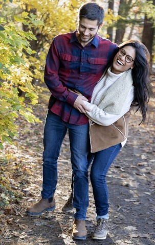 Smiling Young Couple Walks Hand in Hand Through Vogel State Park Forest A young couple, smiling and laughing, walks hand in hand through the scenic forest at Vogel State Park.