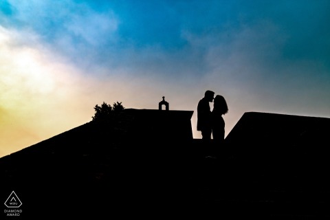 A silhouette pre-wedding portrait of a couple on a rooftop in Lugo, Spain, is a powerful and romantic image.