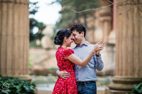 Elegant Engaged Couple Dancing Among Old World Columns In San Francisco Portrait Elegant photo of a couple dancing among the old world columns of San Francisco.