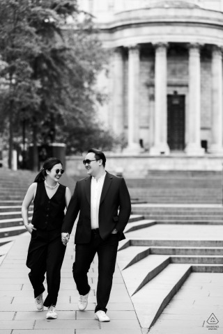 London Shadows: Black Attire, Holding Hands, Forever Walking Into Love Black and white, vertical portrait of a couple walking and holding hands in London, UK, both subjects dressed completely in all black attire.