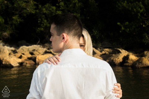 An intriguing and intimate portrait captured in São Paulo, showing a couple whose physical closeness contrasts with the man's averted gaze and the woman's singular, direct eye contact with the viewer.