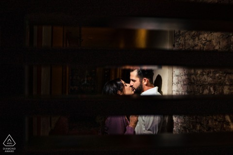 Enclosed Philadelphia Kiss: Two Worlds Merge, Isolation Forgotten in Tender Embrace A portrait capturing a couple lost in their own world, sharing a tender kiss in Philadelphia. The image contrasts their deep connection with the isolation of the enclosed room setting.