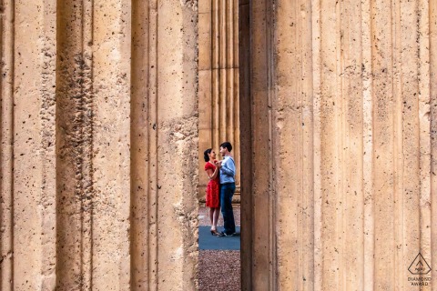 A romantic portrait showcasing a couple's dance viewed through the heavy, stone pillars. The classic architecture of Northern California creates a dramatic, structured backdrop for the fluid motion of the pair.