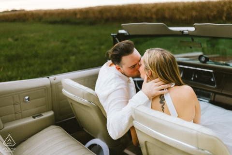 Gambrills Kiss: Vintage Convertible, Intimate High-Angle Love Story Framed Outside Captured in Gambrills, Maryland, this romantic high-angle shot shows a couple kissing inside a vintage convertible car with a white interior, framed from the outside for an intimate portrait.
