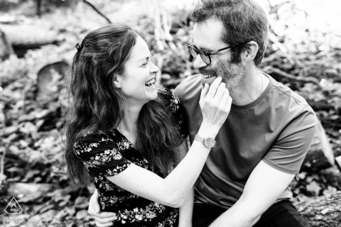 This intimate black and white portrait from the Woodlands in Brookman Park, Hertfordshire, captures the bride tenderly stroking the groom's face, taken from a high angle for a deeply personal view.