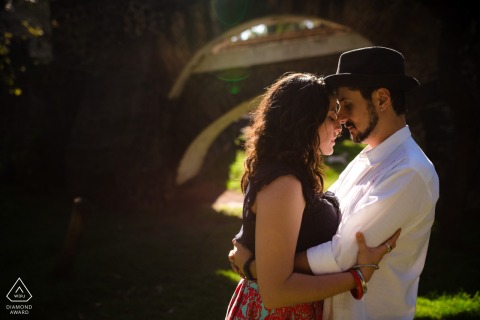 Within the arches of Mexico City, this beautiful portrait captures the couple standing head-to-head with eyes closed, brilliantly backlit by the sunshine for a scene of intimate connection.