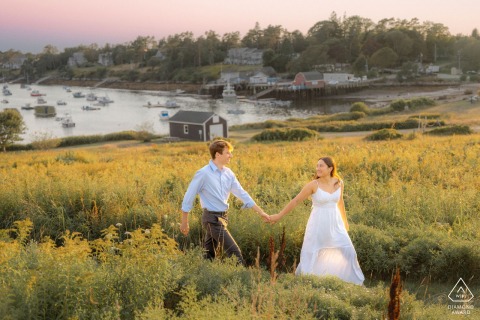 This romantic portrait from Harpswell, Maine, captures the newly engaged couple walking through a field at sunset on Orrs Island, close to the special site where they will eventually get married.