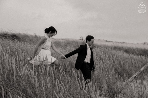 This beautiful black and white portrait at the Dune du Pyla captures the couple walking down the hill, hand-in-hand, seemingly lost and intimate amidst the wild beauty of the fields below.