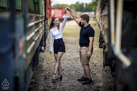 Captured between train cars in Budapest, this joyous portrait shows the couple dancing and smiling, with a shallow depth of field focusing on their playful, loving connection.
