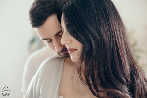 Intimate Shoulder Kiss in Private Atelier Ravenna Couple Portrait Session In a private atelier in Ravenna, Italy, this intimate studio shot shows him standing behind her, gently kissing her shoulder during their love session.