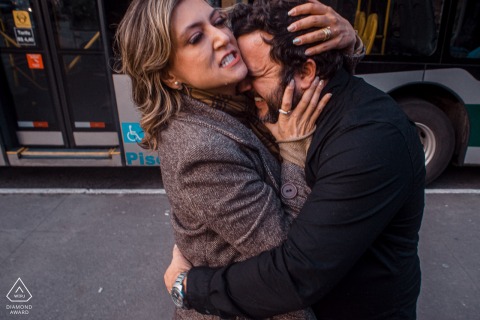 In São Paulo, Brasil, she clings to him as he hugs her tightly, her passionate expression conveying deep emotion in this intimate shot.