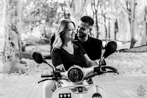 In Toulouse, France, the couple sits together on a scooter, center-framed in a black-and-white portrait just before starting their ride.