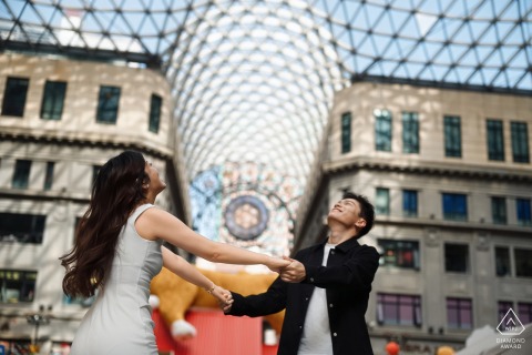 On the Bund in Shanghai, China, the couple stands hand in hand, gazing up at a grand dome and sharing the happiness and beauty of the city together.