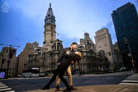 A Joyful Urban Dip Beneath the Arches of Philadelphia City Hall in a Pre-Wedding Portrait Session Beneath the timeless arches of Philadelphia City Hall, the couple shares a joyful, urban dip—full of playful style and grace—where their forever begins.