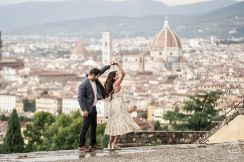 Couple Dancing Playfully On Florence Terrace With Duomo In Background A couple dances playfully on a terrace overlooking Florence, with the iconic Duomo visible in the background, capturing their joyful connection against the historic city skyline.