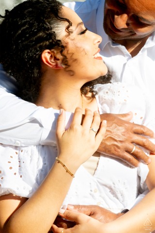 Couple Holding Each Other Joyfully In Sunlight In Porto Alegre, Radiating Happiness In Vibrant Vertical Engagement Portrait Couple standing in sunlight in Porto Alegre, holding each other joyfully, their expressions and body language radiating happiness in this vibrant, vertical engagement portrait.