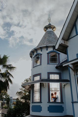 Engaged Couple Posing At Mille Fleurs In Trinidad, Connection Highlighted By Elegant Historic Architecture And Grand Windows Engaged couple poses at Mille Fleurs, one of the historic buildings near Queen’s Park Savannah in Trinidad, their connection highlighted against elegant architecture in this window engagement shoot.