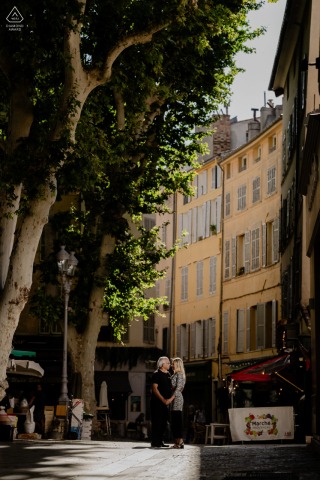 A stylish couple wanders through the historic streets of Aix en Provence, France, during a vibrant street photoshoot that highlights the charm and architectural beauty of this French city.