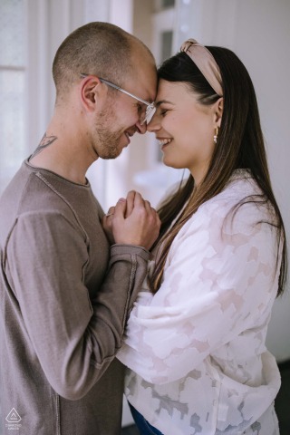 The couple share a quiet and affectionate interaction during their engagement portrait session at the beautiful Villa im Park in Meinerzhagen, Sauerland, North Rhine-Westphalia, Germany.