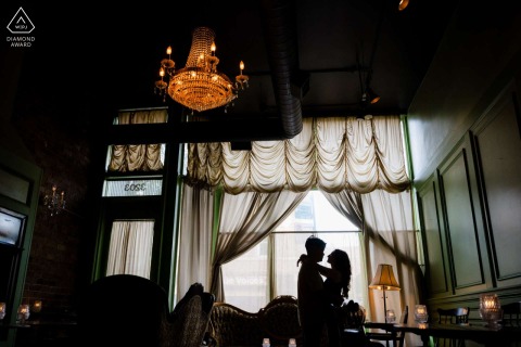 A dramatic silhouette of the couple is captured inside Scofflaw in Logan Square, Chicago, Illinois, highlighting their connection within the moody and stylish atmosphere of this local favorite.