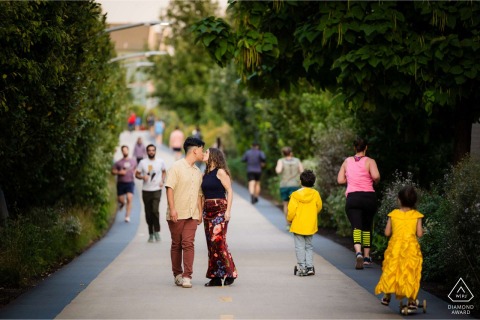 A couple shares a sweet kiss while walking along the 606 Trail in Chicago, Illinois, enjoying a quiet and romantic stroll through the city's unique elevated park and recreation trail.