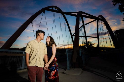 This beautiful sunset portrait captures the couple on the 606 Trail in Chicago, Illinois, as the warm evening light silhouettes them against the popular urban elevated greenway and path.