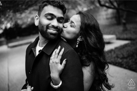 An intimate portrait features the future bride and groom kissing at the Art Institute South Garden in Chicago, Illinois, surrounded by the peaceful and lush greenery of the garden.