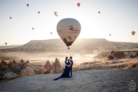 The couple shares an adventurous engagement session in the unique landscape of Cappadocia, Turkiye, surrounded by the iconic rock formations and breathtaking natural beauty of this historic region.
