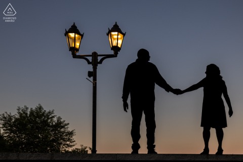 Silhouetted against the evening sky at Brewster Gardens in Plymouth, Massachusetts, the couple’s joined hands speak louder than any detail or expression during this striking and artistic engagement session.