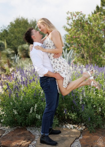 An excited young couple shares a joyful embrace immediately after their proposal at the Houston Botanic Gardens, celebrating their new engagement surrounded by the lush and vibrant greenery of Texas.