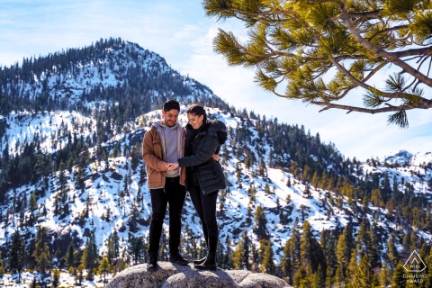 Quiet Joy Is Felt As They Admire The Ring With Snowy Mountain Views In South Lake Tahoe, California A quiet and joyful interaction occurs as the couple admires the engagement ring in South Lake Tahoe, California, with snow-covered mountains and tall pines framing the breathtaking winter view.